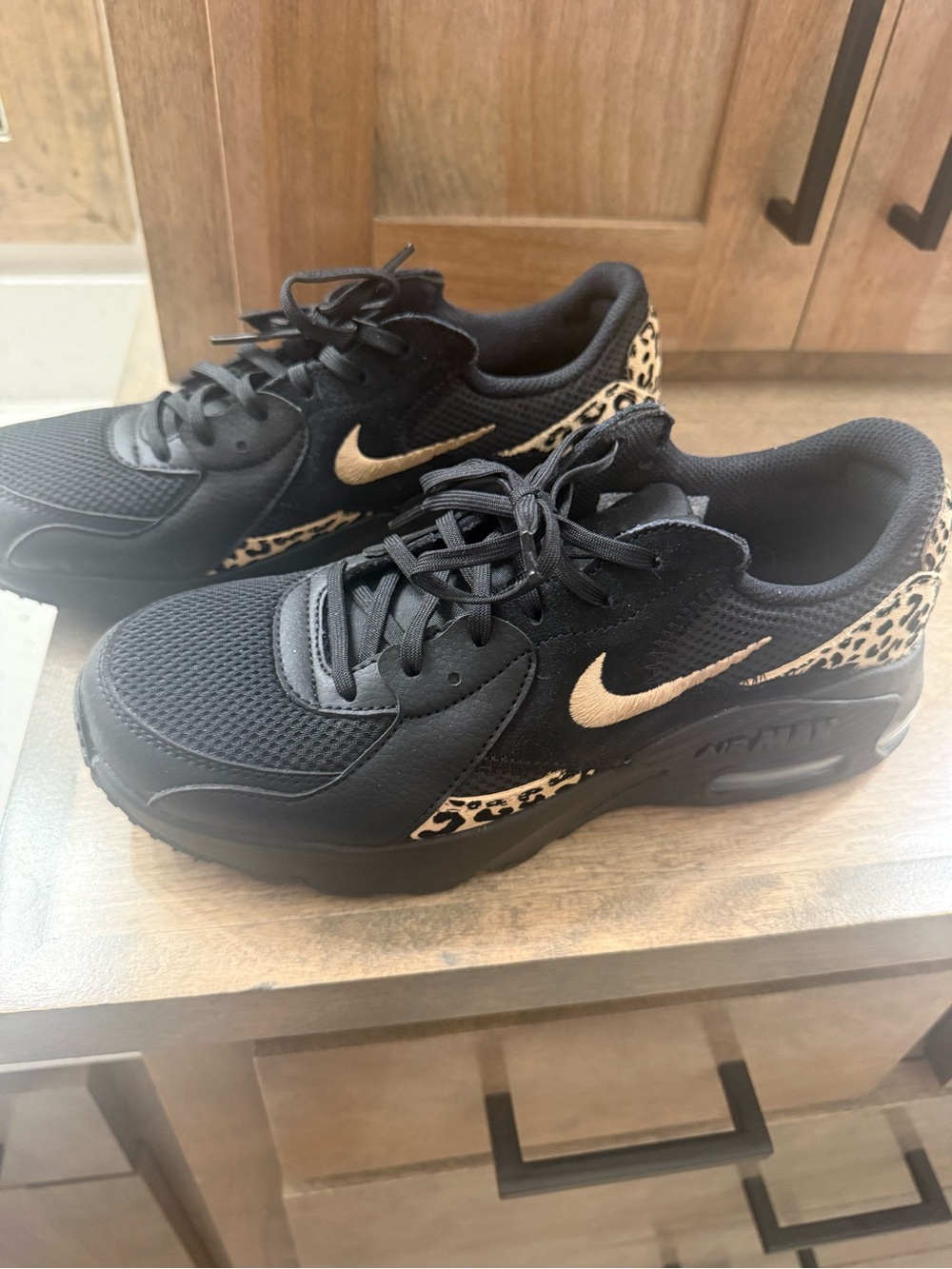 Nike Black Women's Sneakers with Gold Swoosh and Leopard Accents